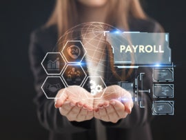 A Mac user holds payroll symbols in her hands.